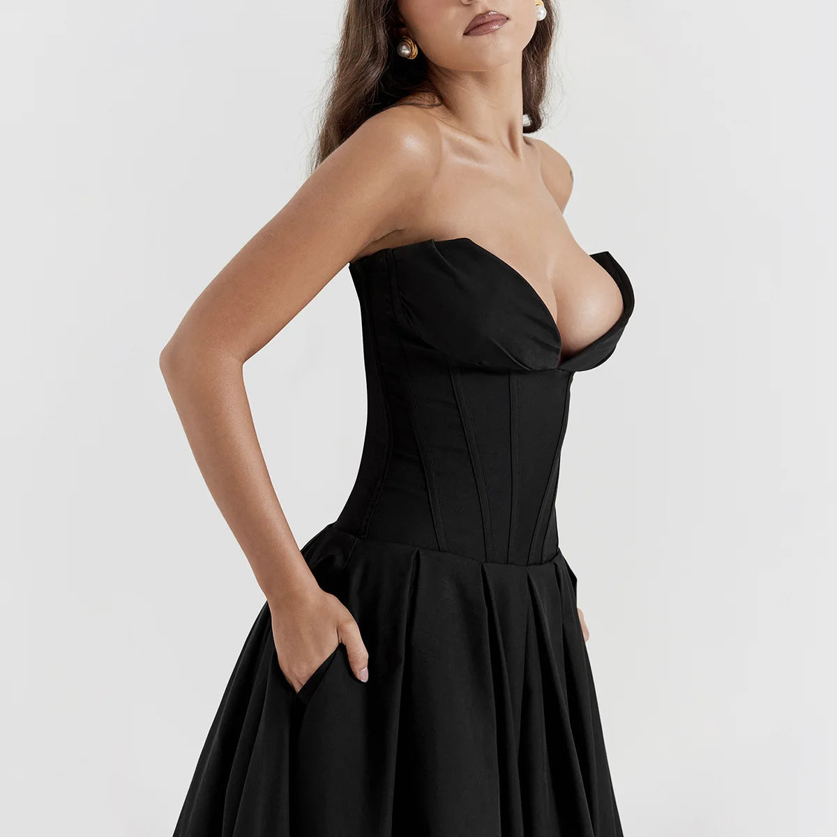 A woman wearing strapless black dress