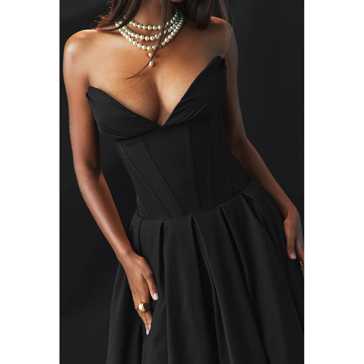 A woman wearing strapless black dress